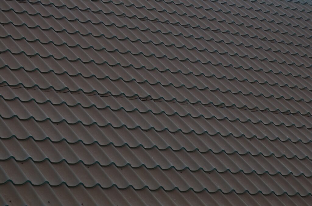 Brown metal roof tiles. Metal Roof Shingles - Roofing Construction